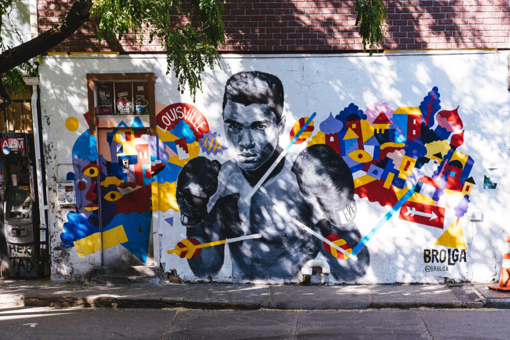 Street art of a man in boxing gloves.